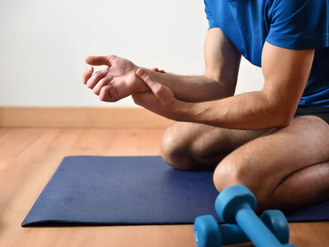 man at gym with wrist pain