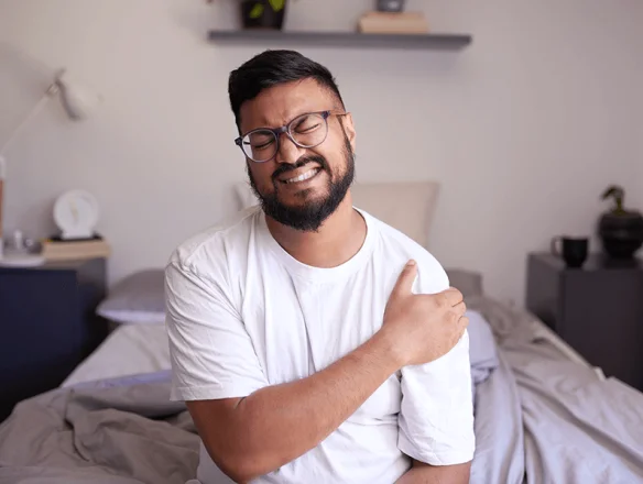 man with shoulder pain after sleeping