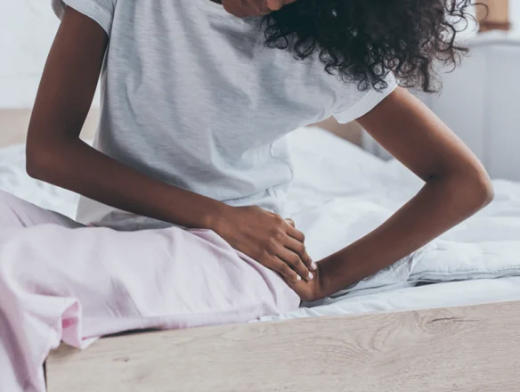 woman holding hip in pain after sleeping