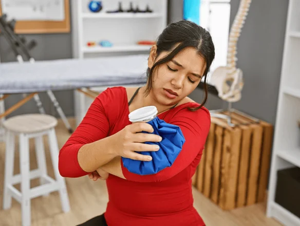 woman using ice on elbow for pain