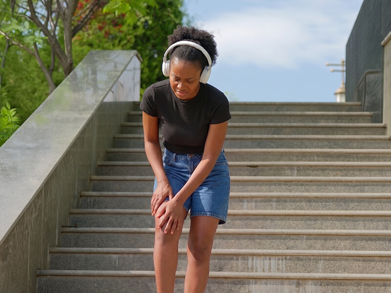 woman with locking knee on stairs