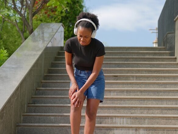 woman with locking knee on stairs