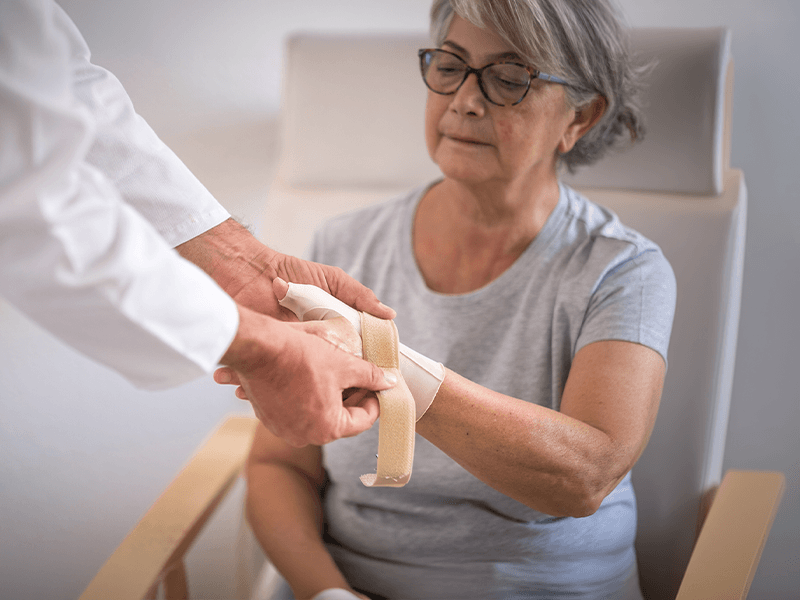 older woman getting fitted for thumb brace